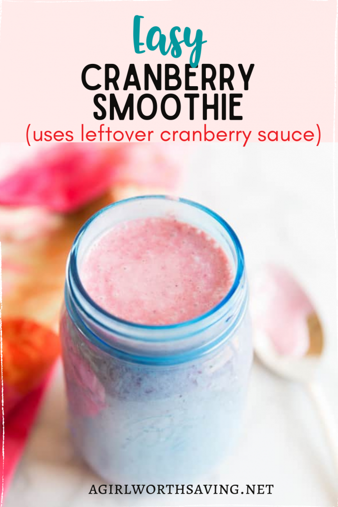 cranberry smoothie in a cup with a spoon on the side