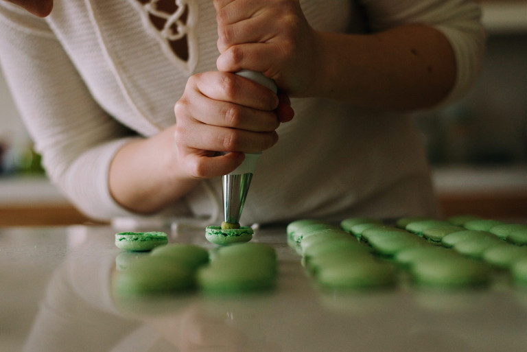 woman baking macarons for sale