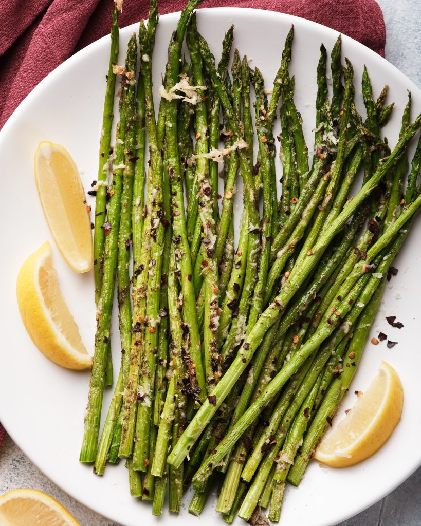 Fresh asparagus on a plate that has been cooked in an air fryer