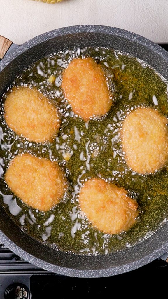 Frying corn nuggets in a skillet filled with hot oil 