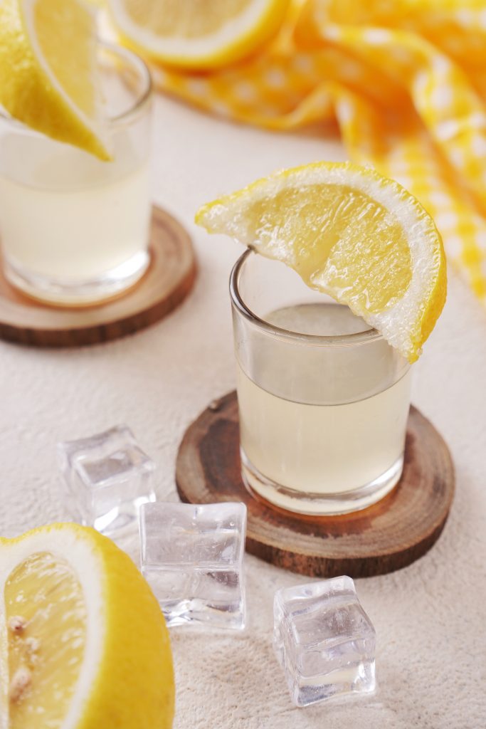 Lemon drop shot on a counter top with ice cubes