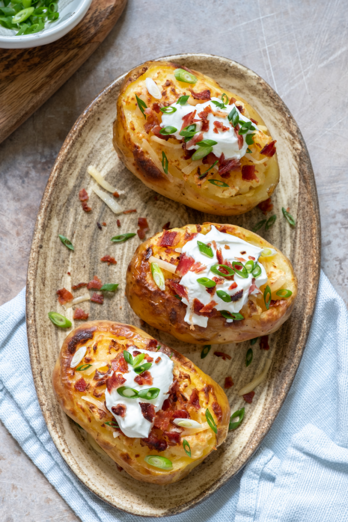 bacon bits on stop of baked potatoes 