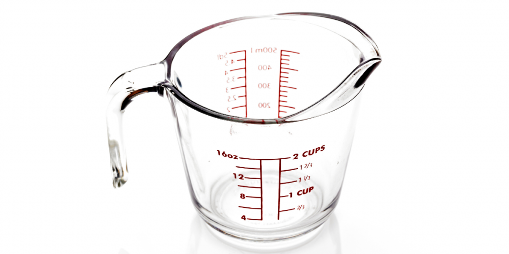 how many ounces in a cup text overlay with a measuring cup in the background 