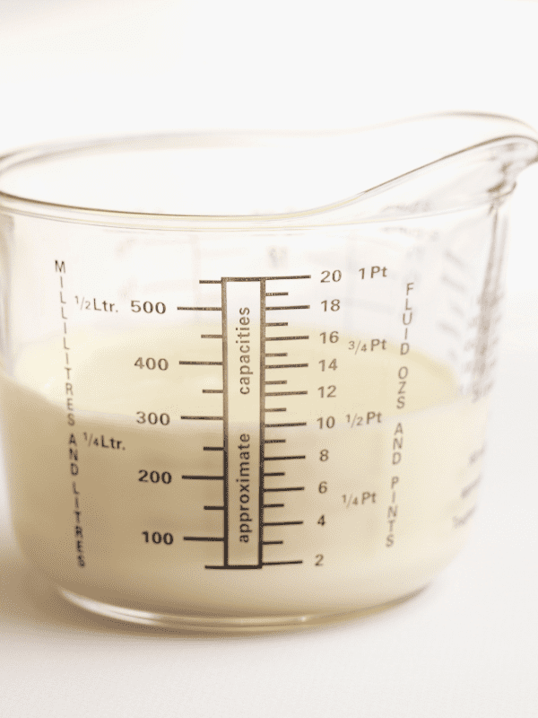 measuring cup with milk inside. 