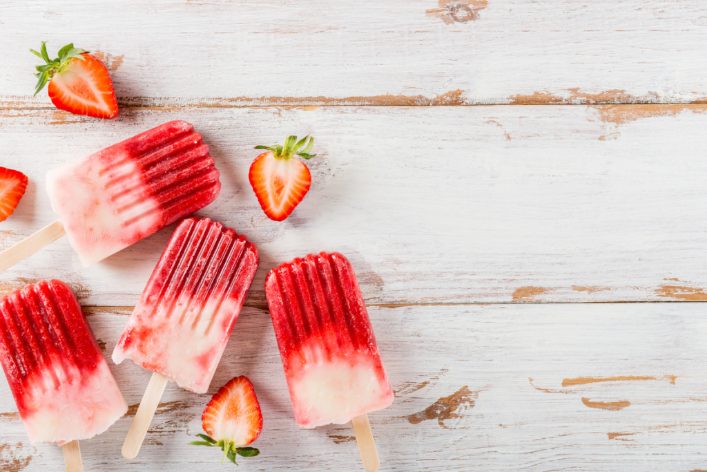 strawberry and cream popsicles on a table top