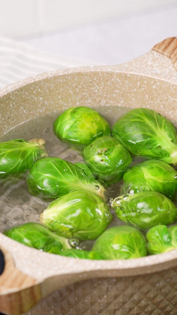 Brussels sprouts cooking in a pot of water 