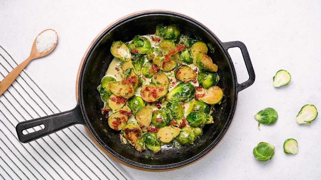 Skillet filled with creamed Brussels sprouts with bacon 