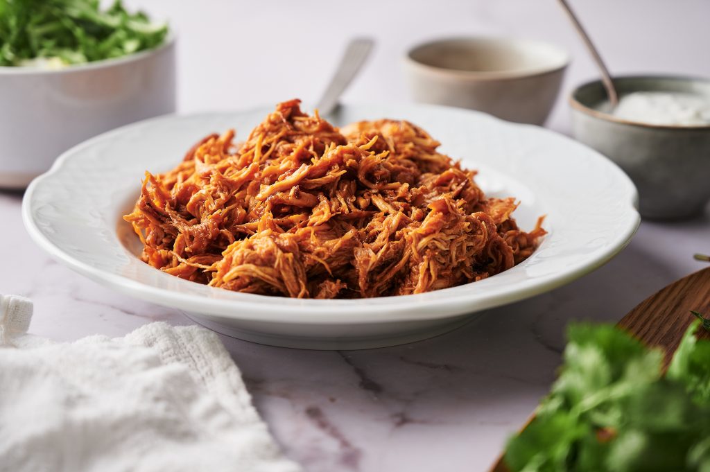 Bowl filled with shredded BBQ Chicken. 