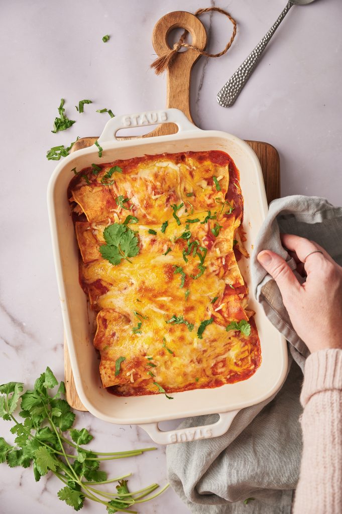 Gluten free Enchiladas are a Mexican dish that is made with corn tortillas, corn or tomato sauce, cheese, and other toppings. The word “enchilada” literally means “to chili (hot pepper) something” in Spanish.