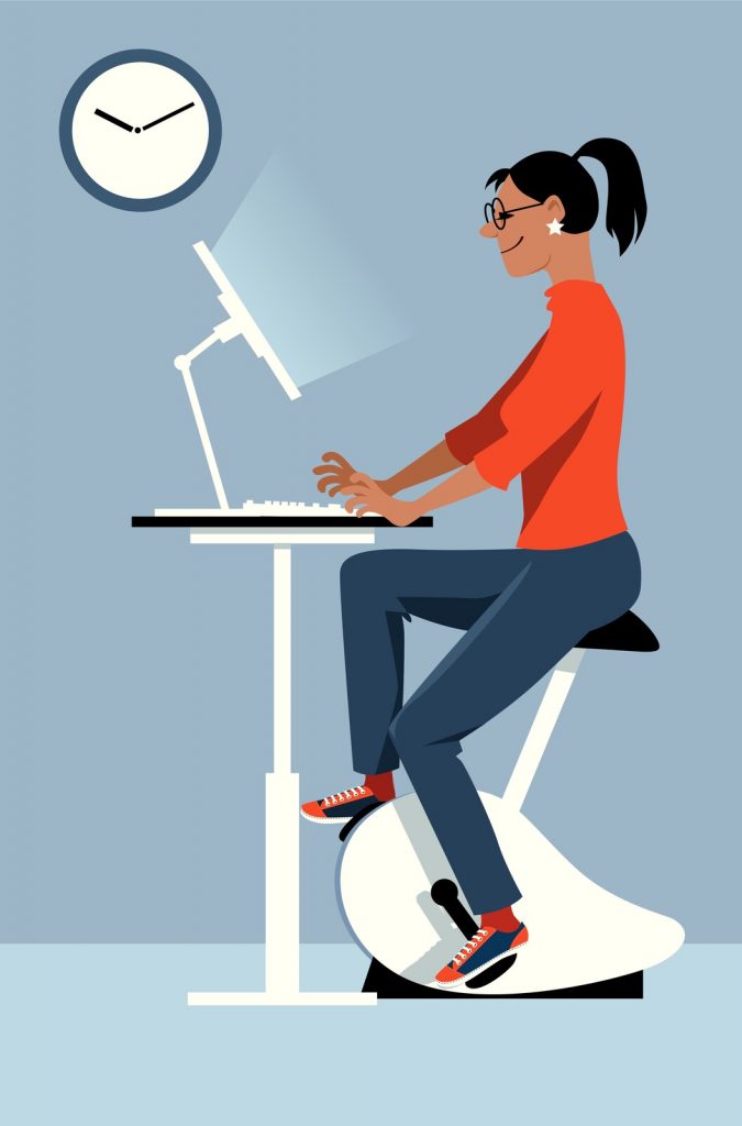 Woman at work on an under desk bike vs elliptical 