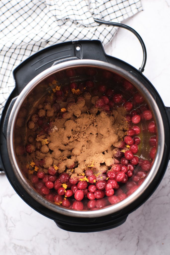 Instant pot filled with cranberries and spices