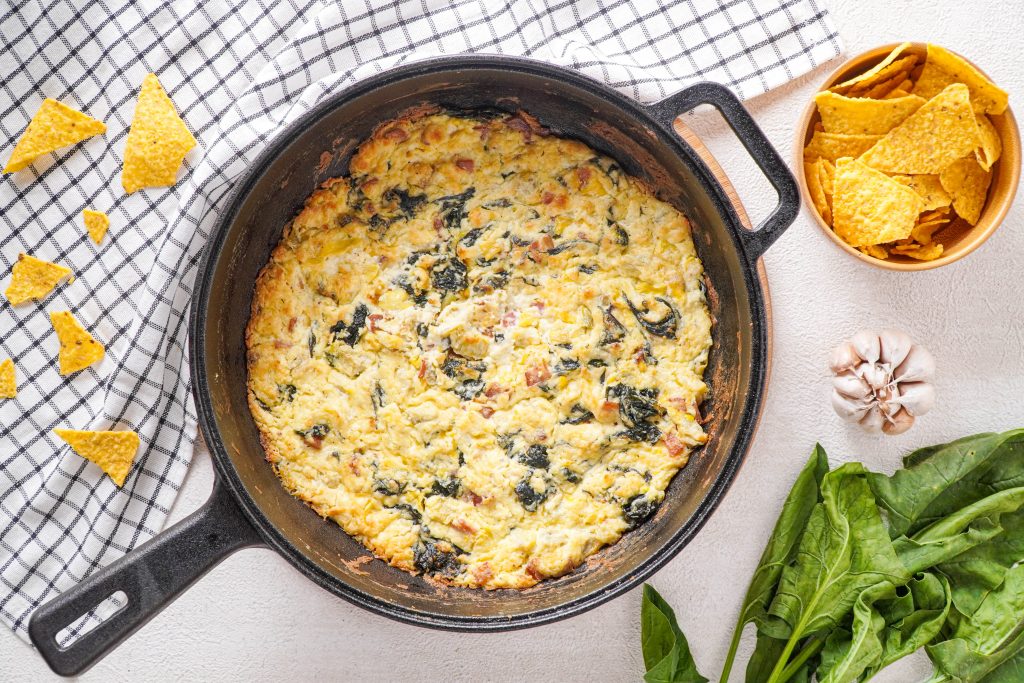 This Keto spinach artichoke dip is rich and creamy and a crowd-pleaser. Packed full of spinach, artichoke, rich cheeses and bacon, you will wow your tastebuds.