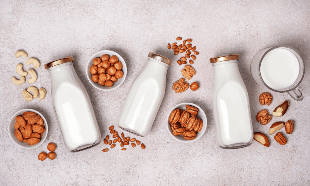 Various Nut Milks on a table made with a nut milk maker 