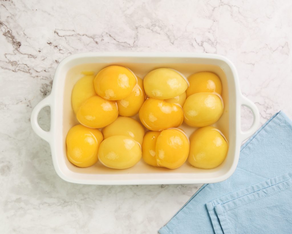 canned peaches in a casserole dish