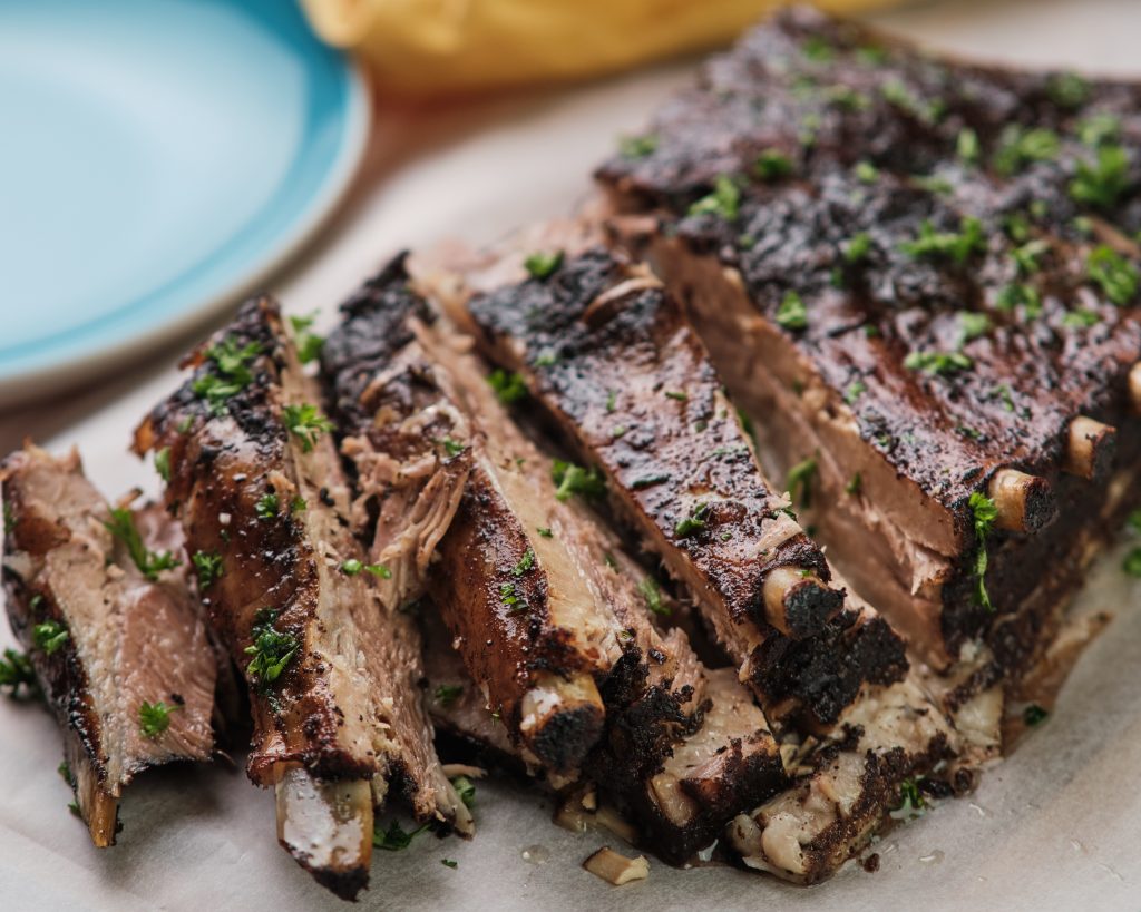 pork spare ribs cut into pieces on top of butcher block paper