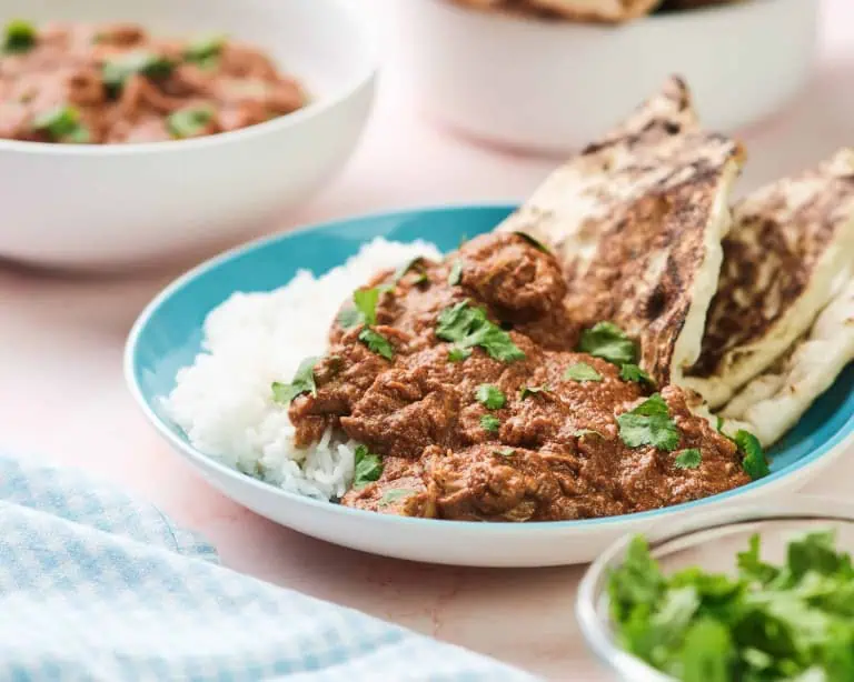 Chicken tikka masala on with rice and naan