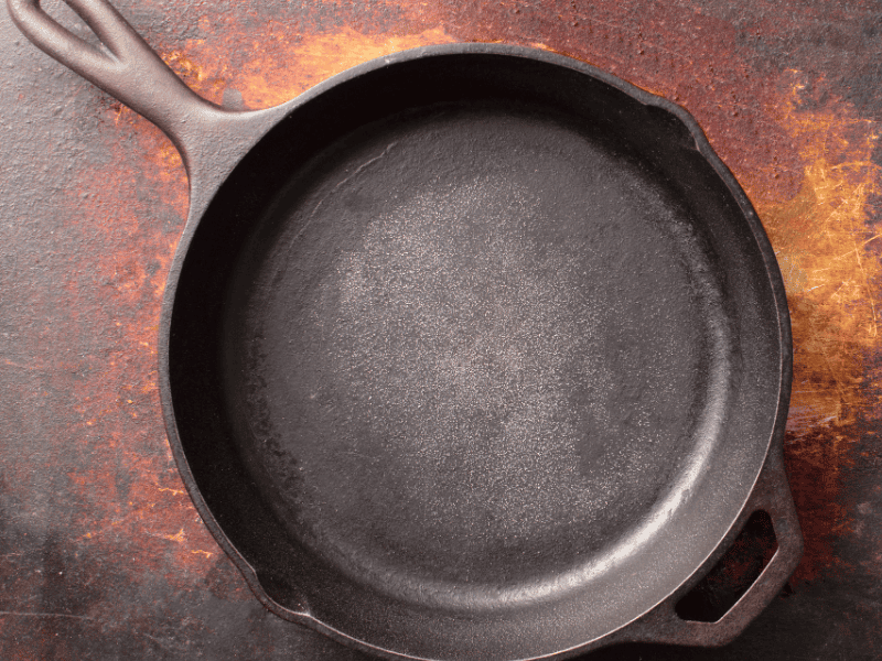 Seasoned cast iron on a rusty looking surface - best oil for seasoning cast iron