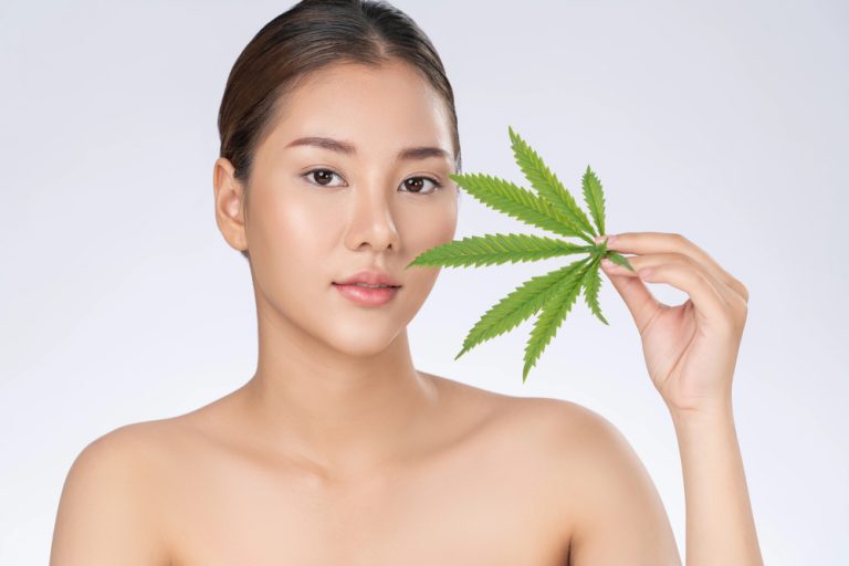 A woman holding a Hemlpleaf up to her face