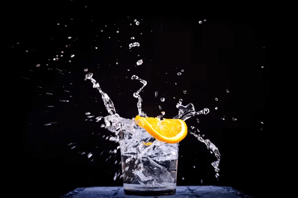 A refreshing glass of water with an orange slice