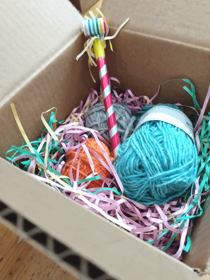 A ball of yarn and crochet hook as a gift for knitters