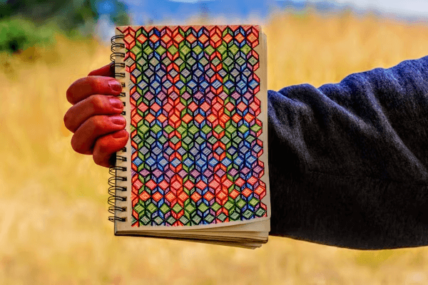 Person holding a notebook for homebody knitters gift idea
