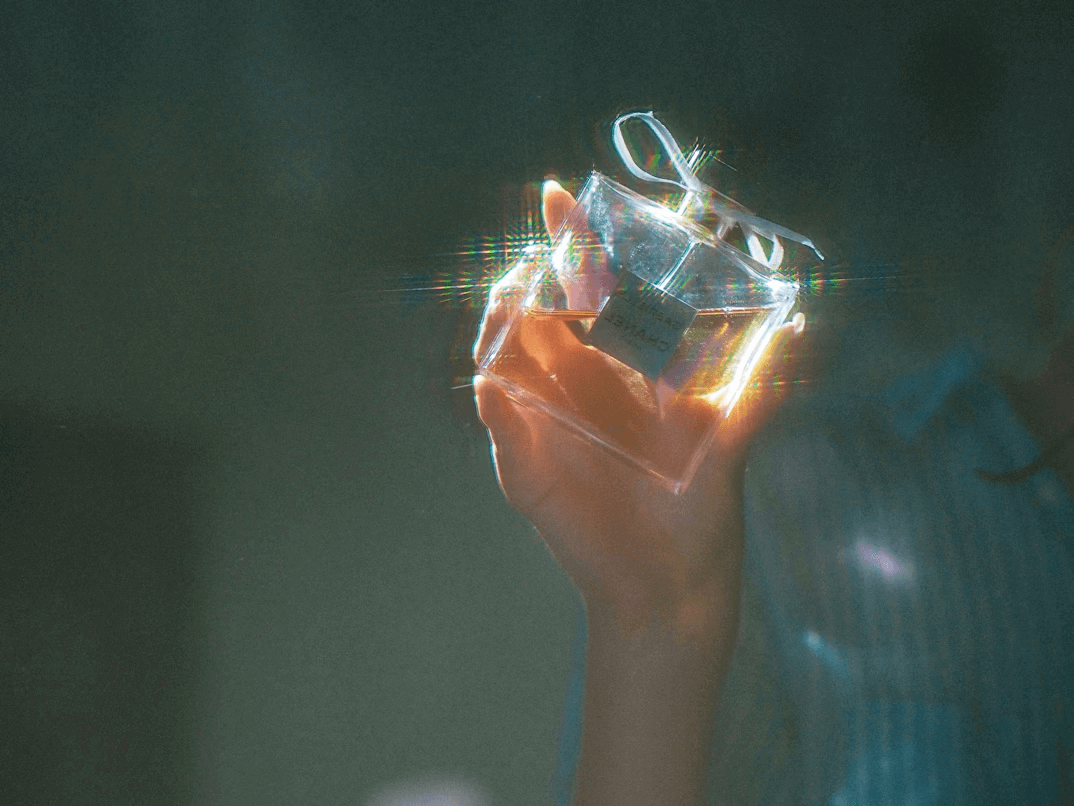 Person holding small object in hand to appear polished