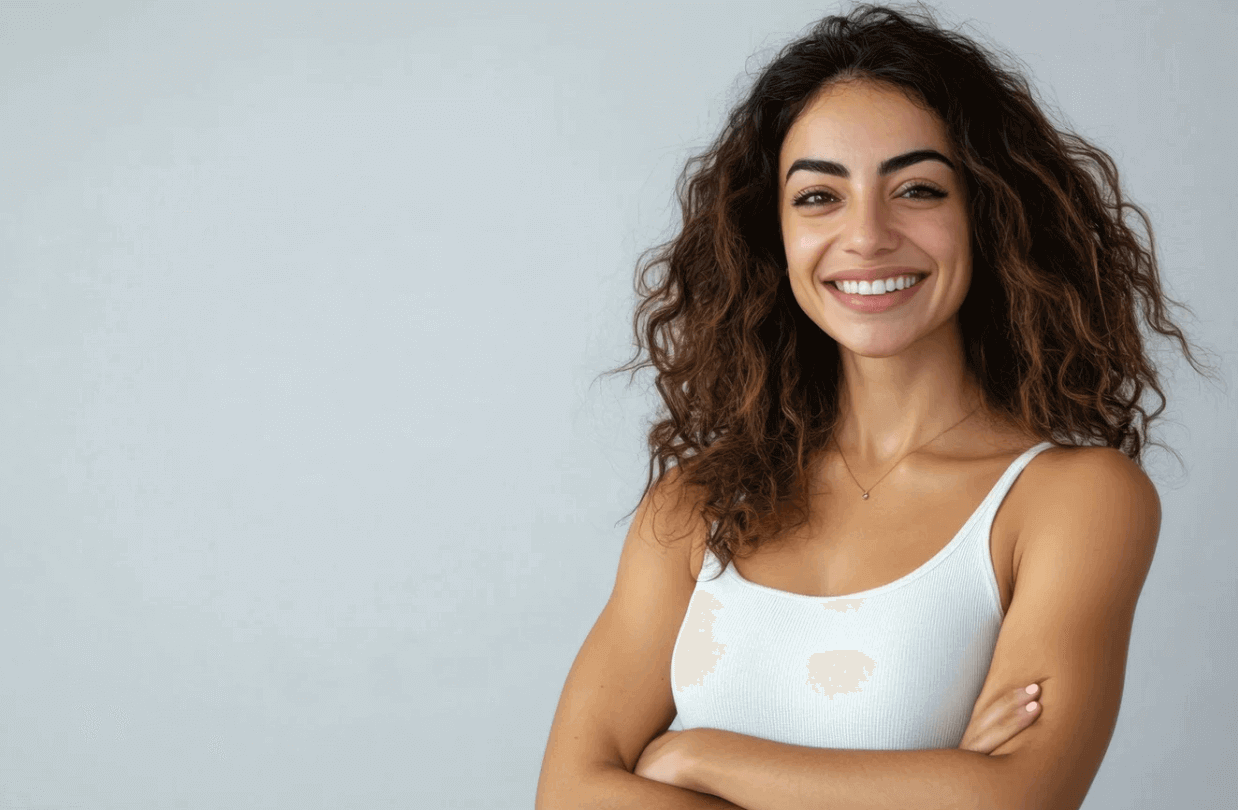 Smiling woman with arms crossed highlighting oral health and self-esteem