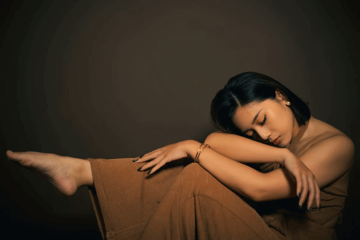 Woman embracing herself with a comforting posture