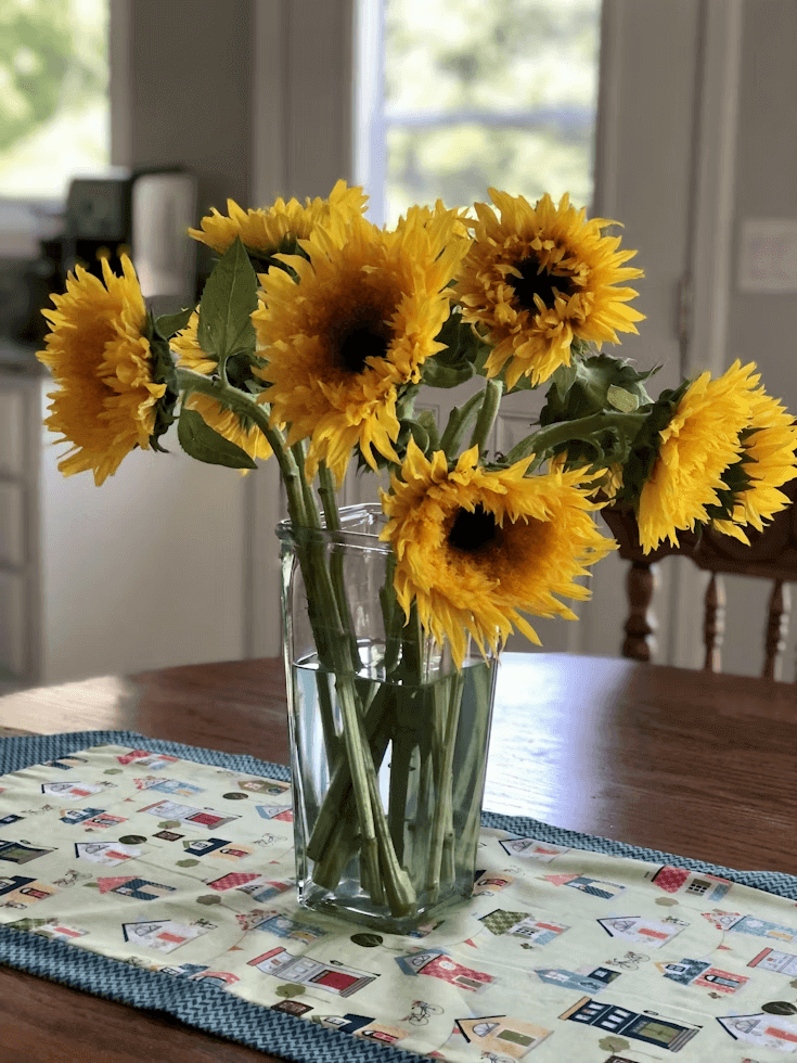 Yellow sunflowers in a vase on a table