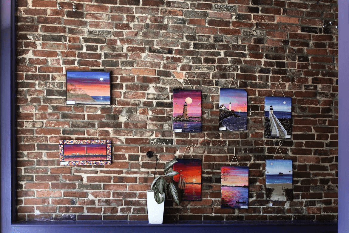 Brick wall adorned with canvas pictures in cozy living room
