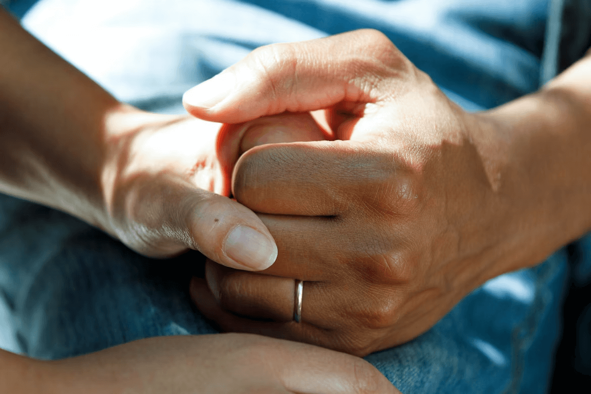 Person offering support through hand holding