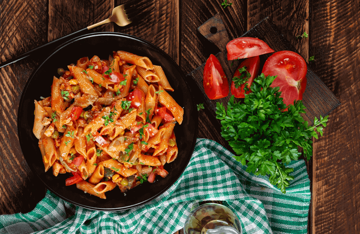 Plate of pasta with tomatoes and parsley for healthy fast food