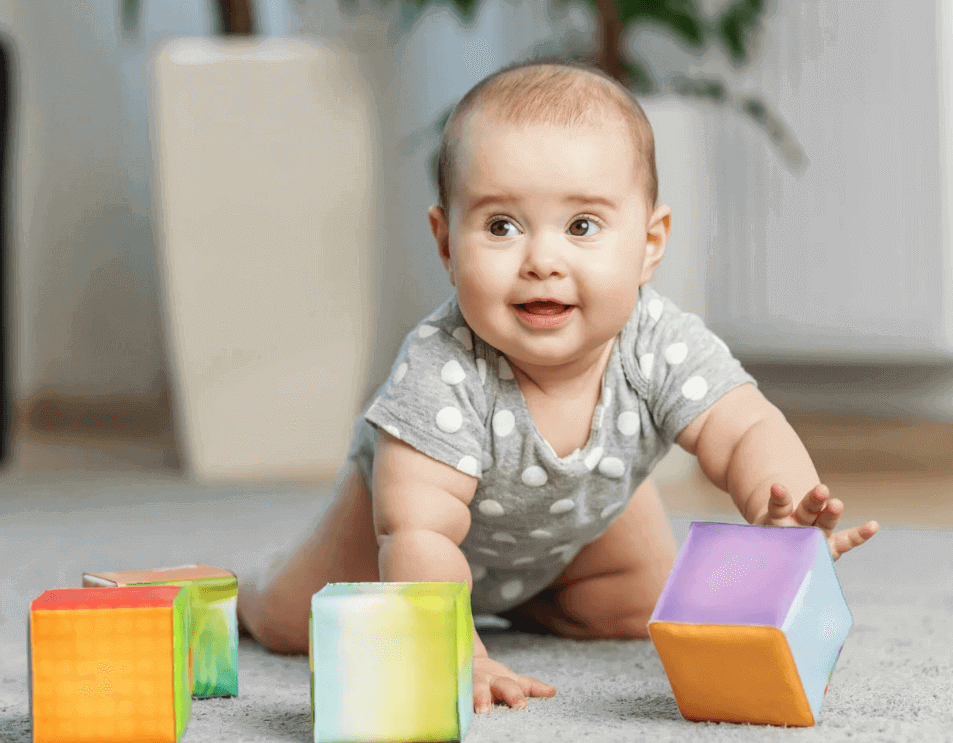 Baby playing with colorful blocks on floor