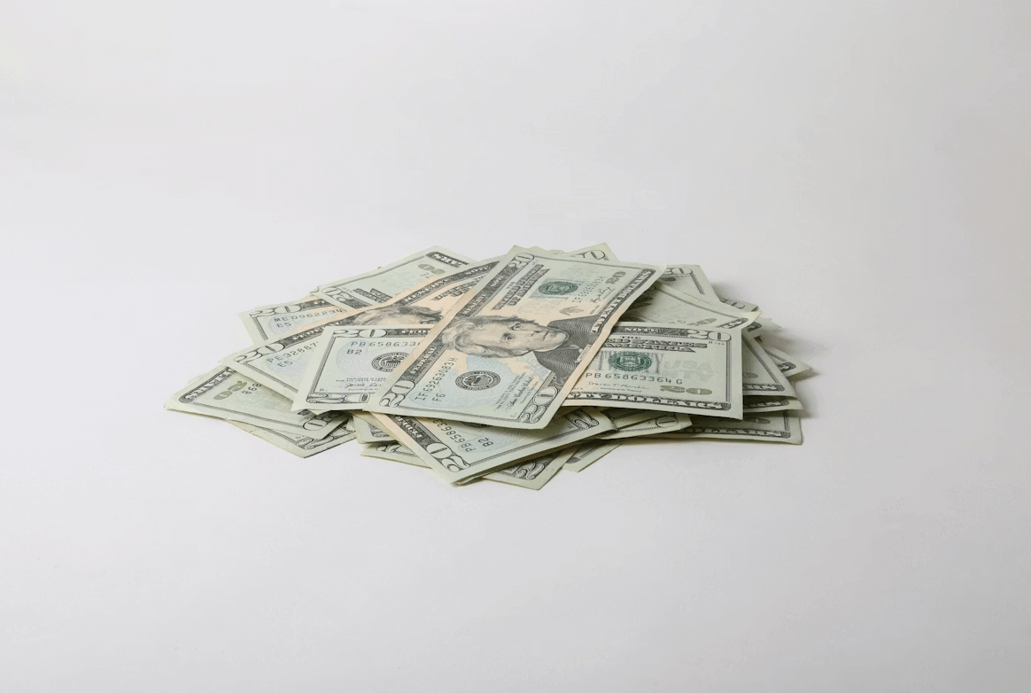 Pile of money on white table representing wrongful death compensation