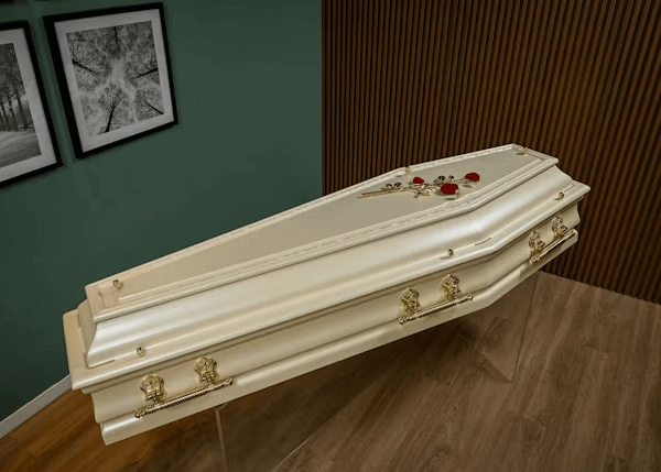White casket on wooden floor