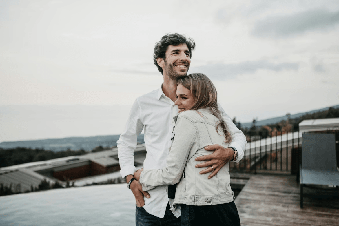 Couple standing by a swimming pool