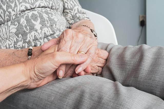 Older woman holding hands with a younger woman