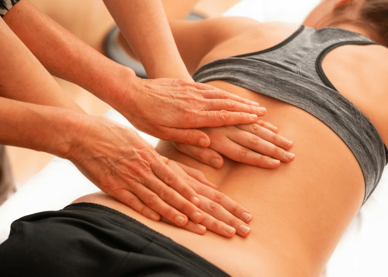 Woman getting a back massage for lower back pain.