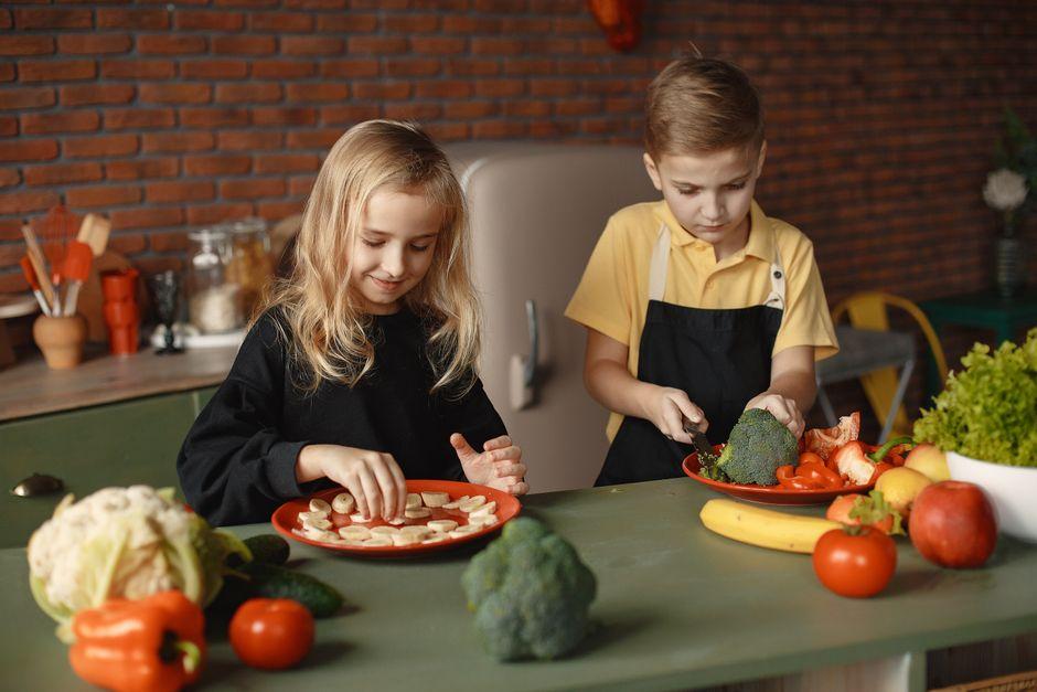 A family cooking together with kids helping prepare fresh ingredients