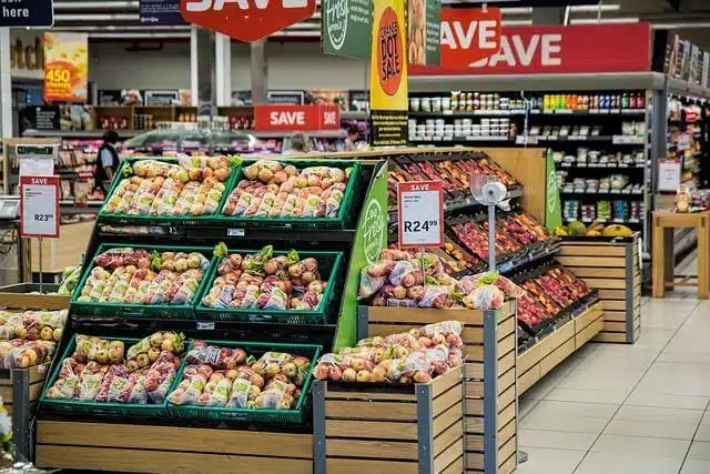 A grocery store aisle filled with fresh fruits and vegetables