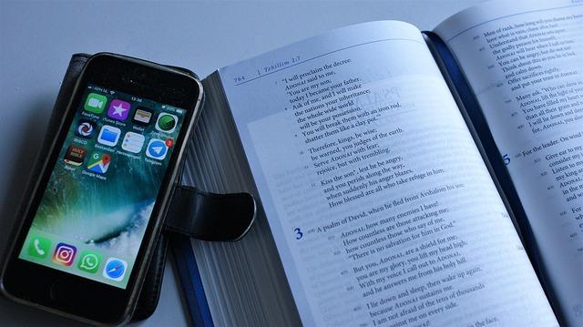An open book and iPhone on a