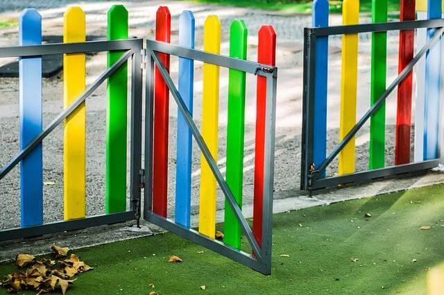 Colorful fence with metal gate opening for a