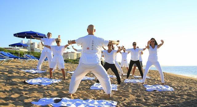 Group of people standing on a sandy beach