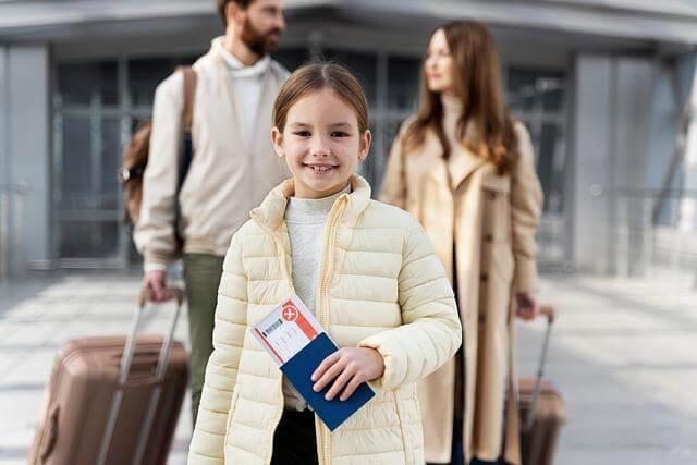 Man and little girl with luggage, representing family immigration