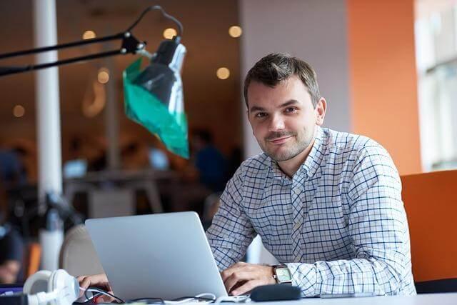 Man on laptop reducing administrative errors in employee pay