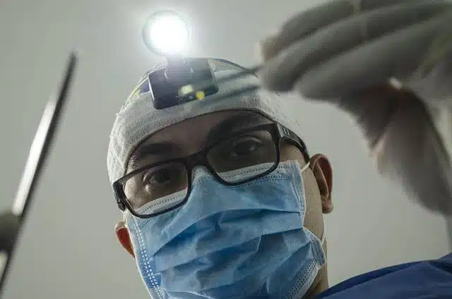 Man wearing a surgical mask and glasses for safe recovery