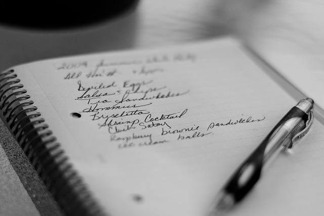 How to Plan Grocery and Essentials Shopping After Moving To A New Home Kelly Bejelly Notepad and pen for planning grocery essentials