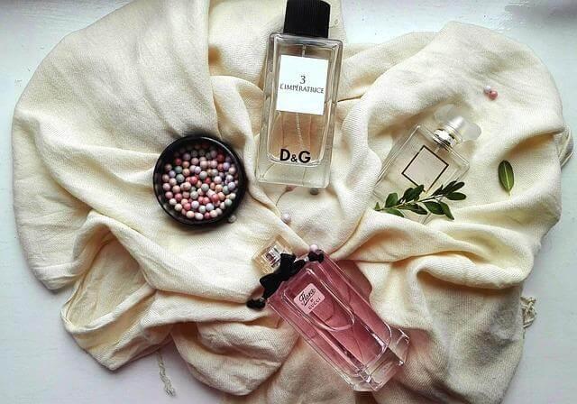 Perfume bottle on a white blanket