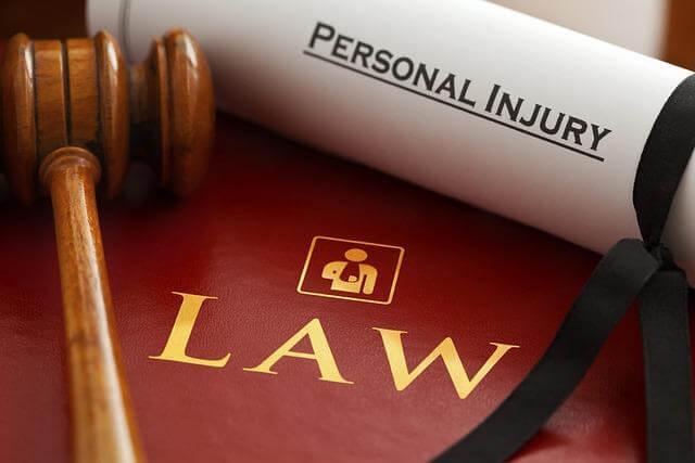 Personal injury law book with a judge's gavel