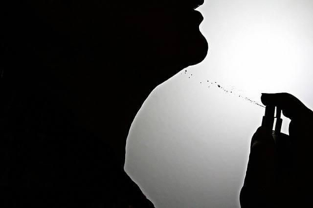 Silhouette of a person holding a cigarette